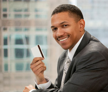 Business man holding a BNI Trade Card