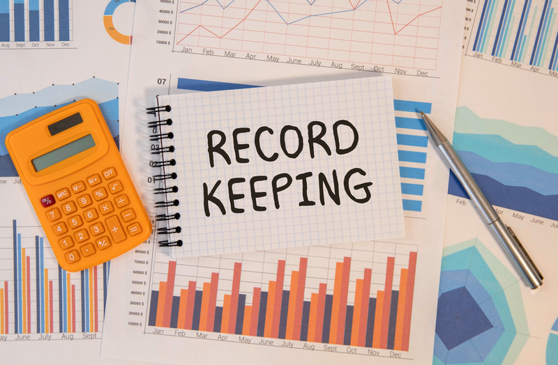 record keeping on white paper card, lens on blue background